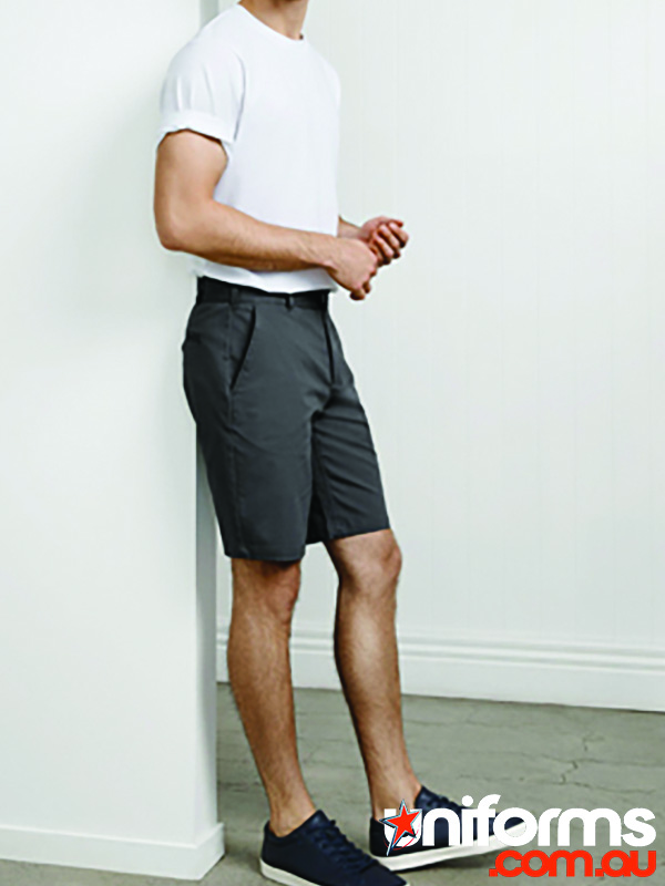 A man in shorts leans against a wall, showcasing the stylish and comfortable BS021M BIZ COLLECTION Men's Lawson Chino Shorts.