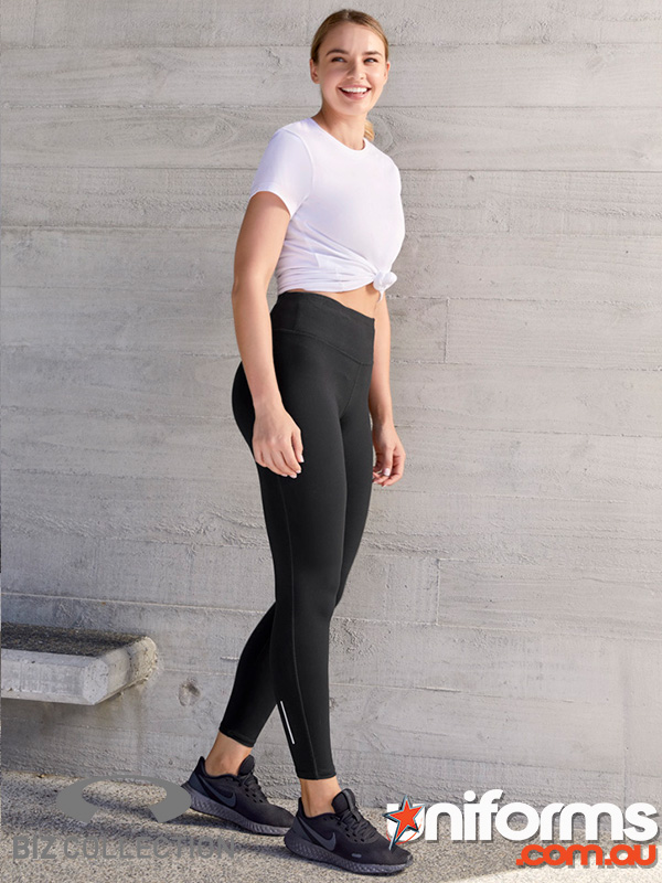 A woman models black leggings, highlighting the Biz Collection Women’s Flex Leggings L514LL in a striking pose for the camera.