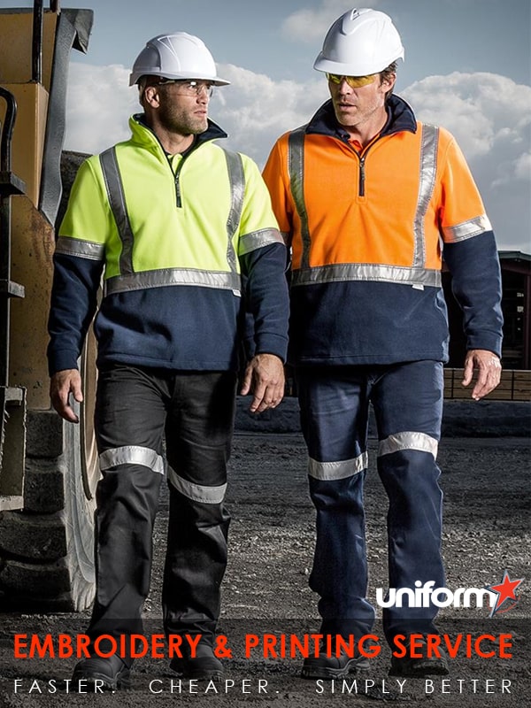 Two men in and hard hats, wearing Syzmic brand Hi Vis Polar Fleece Pullovers, style ZT462, working on a worksite.